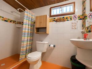 a bathroom with a toilet and a sink at Republika Divanga Homestel in Taganga +19 photos