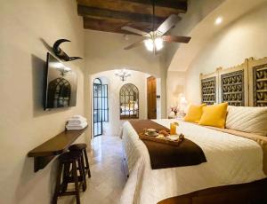 a bedroom with a bed and a desk in it at Casa Grande Luxury Boutique Hotel in San Miguel de Allende +154 photos
