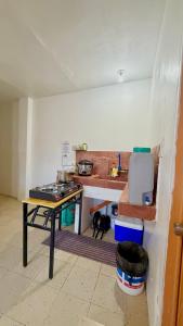 a kitchen with a table and a stove in a room at Maru Vibe Guesthouse V2 in San Juan