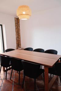 a conference room with a wooden table and chairs at Quinta da Shambhala in Soriço +59 photos