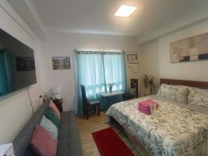 a small bedroom with a bed and a table at Hailey's Place in Bacolod +15 photos
