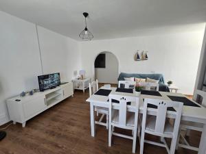 a living room with a table and chairs and a couch at Casa Memela 6 in Tías