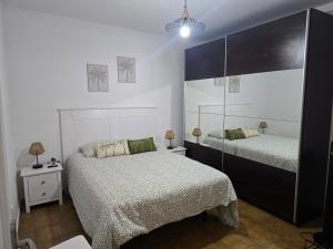 a bedroom with two beds and a mirror at Casa Memela 6 in Tías