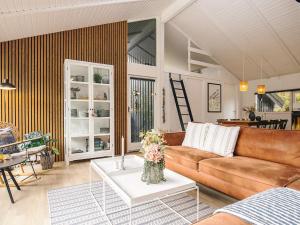 a living room with a couch and a table at 5 star holiday home in Bindslev in Bindslev