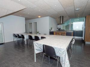 a large kitchen with a long table and chairs at Luxury Retreat in Vorupor in Snedsted