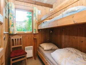 a bedroom with two bunk beds and a window at 8 person holiday home in Hovborg-By Traum in Hovborg