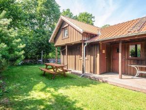 a wooden cabin with a picnic table in the yard at 8 person holiday home in Hovborg-By Traum in Hovborg