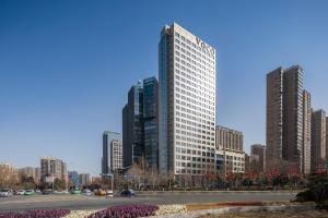 a city skyline with tall buildings and a street at voco Xian ETDZ by IHG in Xi'an