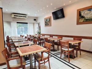 a dining room with wooden tables and chairs at Village Garden Apart Hotel in Buenos Aires