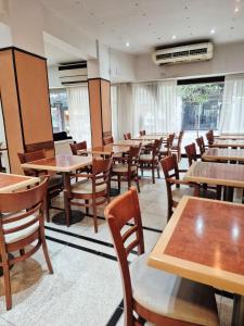 a dining room with wooden tables and chairs at Village Garden Apart Hotel in Buenos Aires