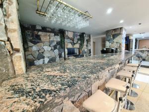a bar in a room with a stone wall at Village Garden Apart Hotel in Buenos Aires +38 photos