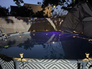 a pool of water with a tent and lights at Casona Los Sidoros Ciudad de Berja in Berja