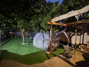 a hammock under a tree in a backyard at night at Casona Los Sidoros Ciudad de Berja in Berja