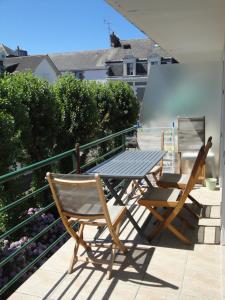 une table et deux chaises assises sur un balcon dans l'établissement Le Pouliguen, au Pouliguen