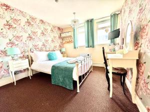 a bedroom with a bed and a desk and a desk at The Hurstmere in Blackpool