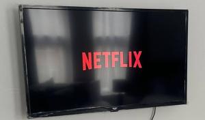 a television screen with the netflix logo on it at Spacious Large Group House Near NEC and Airport in Birmingham