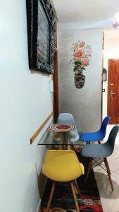 a dining room with a glass table and two chairs at Apprt Ennakhil 2 in El Jadida +41 photos