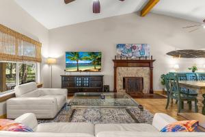 a living room with a couch and a fireplace at The Sebastian Surf Lodge in Vero Beach