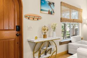 a room with a table and a surfboard on the wall at The Sebastian Surf Lodge in Vero Beach +86 photos