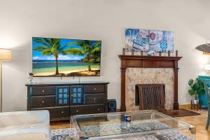 a living room with a glass coffee table and a fireplace at The Sebastian Surf Lodge in Vero Beach