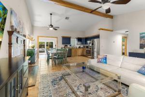 a living room with a white couch and a table at The Sebastian Surf Lodge in Vero Beach