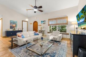 a living room with a white couch and a table at The Sebastian Surf Lodge in Vero Beach
