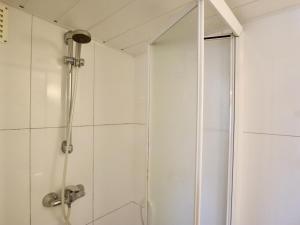 a shower with a glass door in a bathroom at Sous les Hetres in Robertville +27 photos