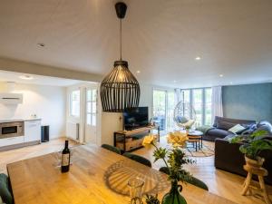a living room with a table and a couch at Villa Fox in IJhorst