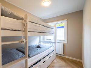 a bedroom with two bunk beds and a window at Villa Fox in IJhorst +36 photos