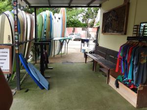 a group of surfboards are lined up in a store at The Frontside Surf House in Tamarindo +1 photo