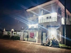 a white house with lights on it at night at Duswin Hotel Gloucester, Freetown, SL in Freetown
