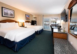 a hotel room with two beds and a balcony at King Frederik Inn in Solvang +67 photos