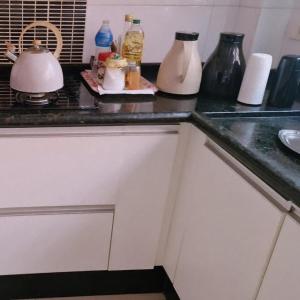 a kitchen counter top with vases on top of it at Pousada Brisa da Mata in Londrina