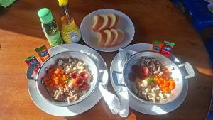 a table with two bowls of food and bread at นัชชานามุงโฮมสเตย์ in Ban Mung +21 photos