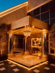 a lobby of a building with columns and a painting at E-Luxe Suites Hotel in Abuja