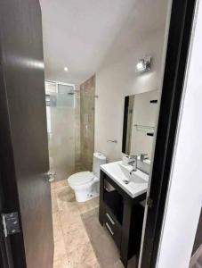 a bathroom with a toilet and a sink and a mirror at tulum in Tulum
