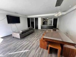 a living room with a couch and a table at tulum in Tulum