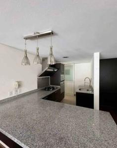 a kitchen with black and white appliances and a counter top at tulum in Tulum