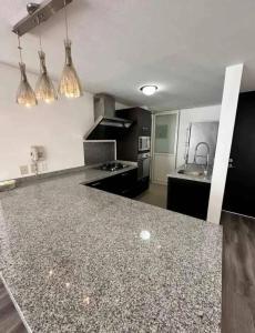 a kitchen with a granite counter top in a room at tulum in Tulum