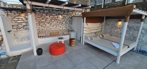 a porch with two bunk beds on a patio at 3 SENSES villa in Dhriopís +97 photos