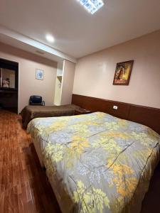 a bedroom with two beds in a room with at Hotel Nerja in San Juan