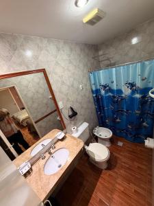 a bathroom with a sink and a toilet and a shower at Hotel Nerja in San Juan