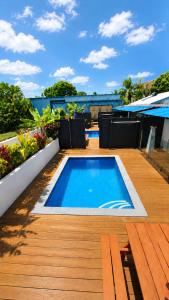 a swimming pool on top of a wooden deck at Konoha Central 9BR, 3 Pools, Sleeps 24 in Avarua