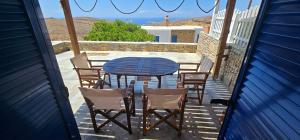 a table and chairs on a porch with a view of the ocean at 3 SENSES villa in Dhriopís