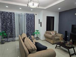 a living room with two couches and a tv at Modern House with Private Pool in Santa Rosa de Copán
