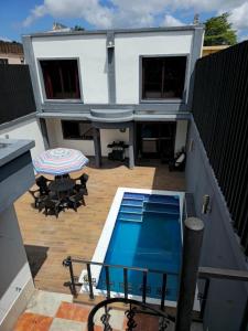 a balcony with a swimming pool and a house at Modern House with Private Pool in Santa Rosa de Copán