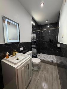 a bathroom with a sink and a toilet and a shower at Hotel Gods Blessing in Nebaj