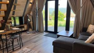 a living room with a couch and a table at Breeze Cabin كوخ النسيم in Ilijaš