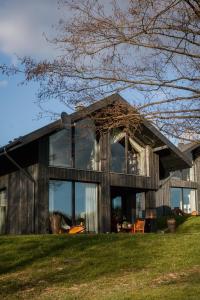 a house with large glass windows at CHATY U HARREGO NAD STAWEM SPA sauna, balia, rowery, klimatyzacja, in Kudowa-Zdrój