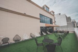 a patio with tables and chairs on a building at 호텔 인썸니아 Hotel Insomnia 失眠酒店 in Daegu